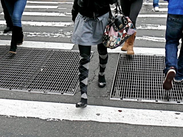 Argyle tights highlight a short drop waisted skirt and flats on Grand Street SoHo.