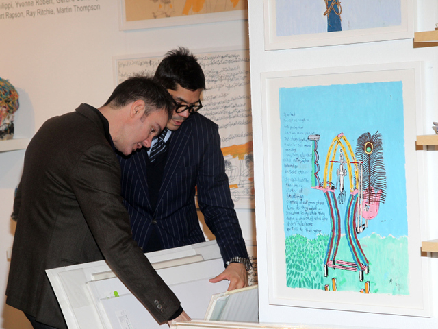 Guests check out art at the Outsider Art Fair.