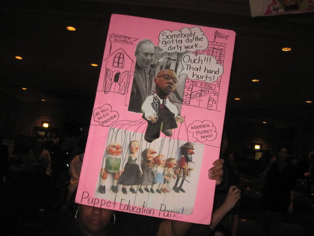 Dozens waved colorful signs like this blasting the administration. 