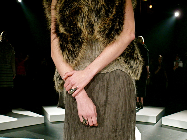 Detail of Abella in Black Gold SAGA fox bolero, coiling mohair / cashmere and crinkle chiffon gown, and Castro NYC for Brandon Sun rings.