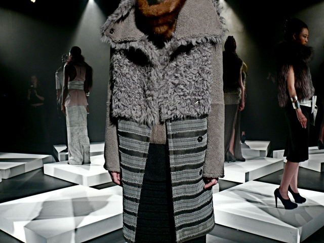 Layered details of storm gray shearling with reptilian lace trim.