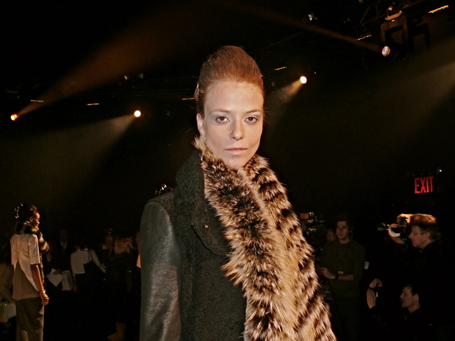 Ralissa wearing a black shearling coat with leather sleeves, a black gold SAGA fox, the matte and shine trend.
