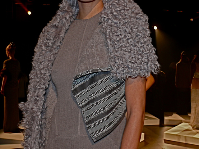 Detail of Amanda in gray shearling stole with reptilian trim.