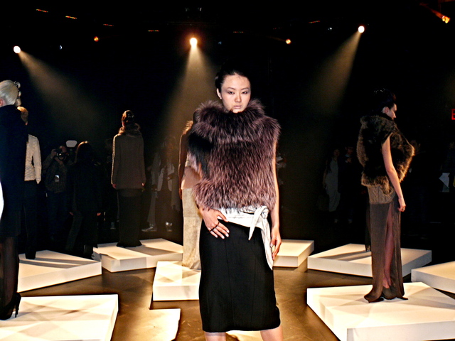 Samantha Xu in dusk rose SAGA silver fox pullover, and a black pencil skirt, with a blizzard crack leather obi belt.