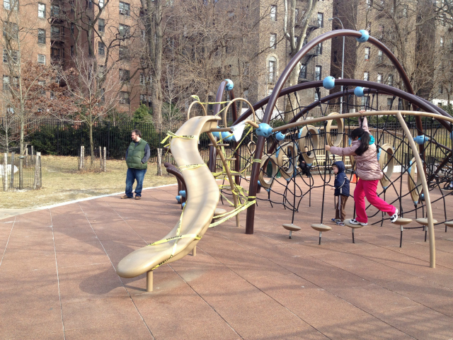 Children played around the taped off slide on Saturday, February 18, 2012.