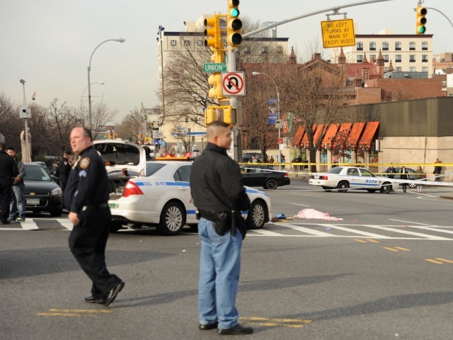 Cops looked in the aftermath of a woman being struck and killed by a city bus in Flushing on Feb. 22, 2012.