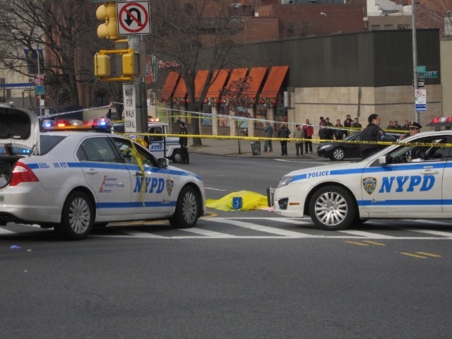 The body of a woman who was struck and killed by a city bus lay at the intersection of Northern Blvd. and Union St. on Feb. 22, 2012.