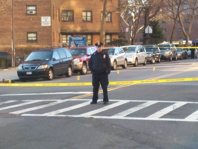 A police officer stands guard after cops and a suspect had a shootout near Columbia St. on the Lower East Side on Feb. 27, 2012.