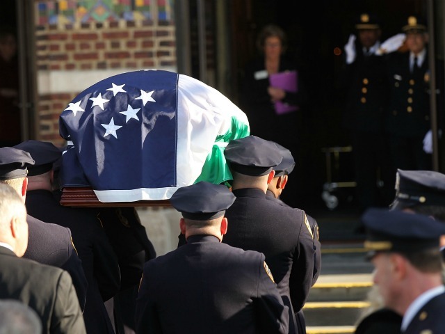 The casket of police officer Peter Figoski is brought into a church during the funeral for the New York City police officer who was killed last week while responding to a robbery at St. Joseph’s Church on December 19, 2011 in Babylon, New York.