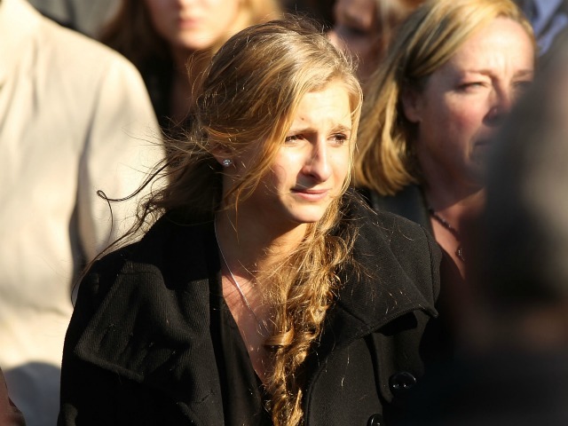 Corrine Figoski, 14, one of the four daughters of murdered NYPD officer Peter Figoski leaves following the funeral at St. Joseph’s Church on December 19, 2011 in Babylon, New York. 
