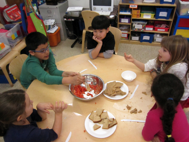<p>Students stir a tomato mixture during a cooking lesson at the East Village Community School, one of the schools in District 1.</p>
