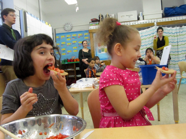 <p>Students taste the healthy version of bruschetta that they made as part of the Food Bank's CookShop program at the East Village Community School.</p>
