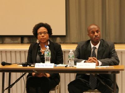 Marsha Vernon, Schomburg's principal, and Colin Thomas, principal of Bronx Regional, listen to speakers at the hearing.