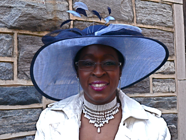 June B. in shades of periwinkle and navy blue structured wide brim with plume and bow details.