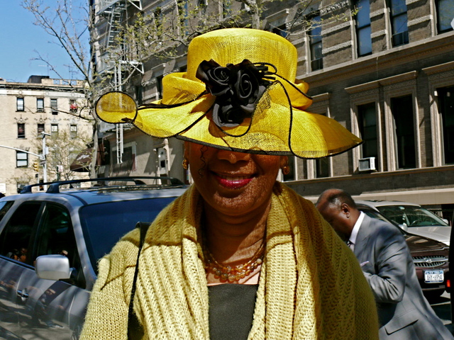 Michelle A. in a light straw with a raised crown and abstract bow and floral detail.