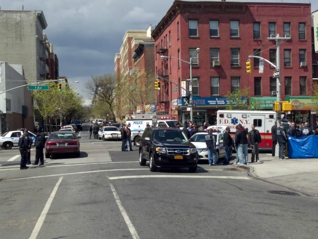 Police shot and killed a man robbing an East Harlem pharmacy and were hunting for another alleged robber.