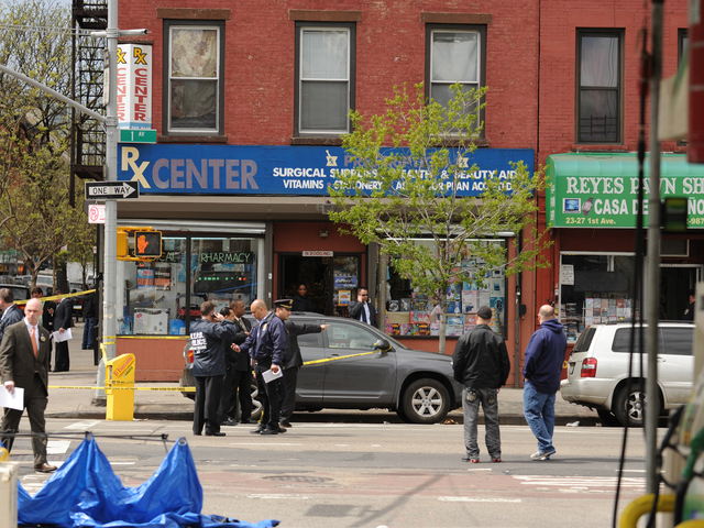 The blue tarp marks the spot where the suspect was shot on April 12, 2012.