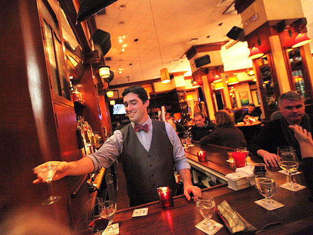 <p>Ryan Favorite, 26, tending the bar at Henry's Restaurant.</p>
