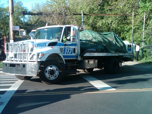 Police remove the crushed Honda Pilot from the scene of the April 29 Bronx crash. 