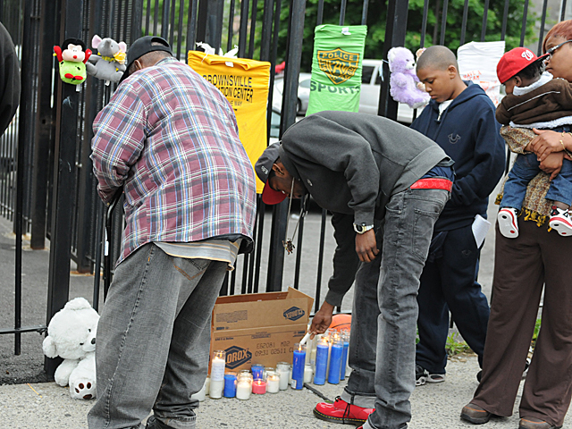 Mourners light candles at a memorial for Yakim McDaniels, May 7, 2012. 