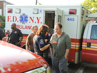 <p>An EMT talks to a patient's family outside an ambulance. A small group of New York City EMTs and paramedics, led by former FDNY EMT Walter Adler, are working to create the first citywide advocacy organization for emergency medical workers.</p>
