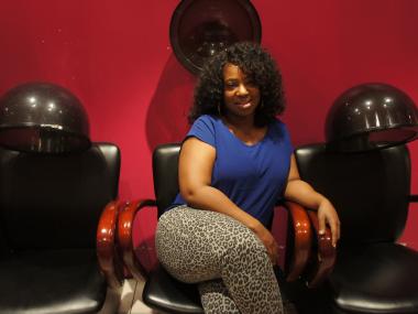Ebony Fletcher at the Crown Heights salon where she works. Fletcher was shot twice by an ex-boyfriend and left for dead. Thanks to a grant from Verizon Entrepreneurship Training Initiative, a special fund for survivors of domestic violence, she was able to launch a haircare line.
