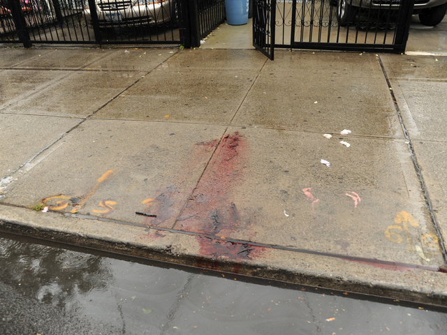 Blood from the deceased remains in front of 2814 West 15th Street in Brooklyn on Monday June 4th, 2012.