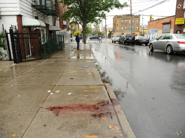 Blood from the deceased remains in front of 2814 West 15th Street in Brooklyn on Monday June 4th, 2012.