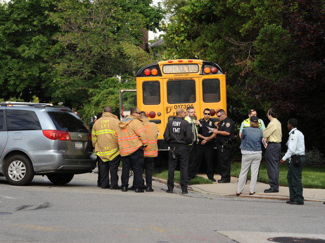 <p>Officials at the scene of a school bus crash in Queens on Tuesday June 5, 2012.</p>
