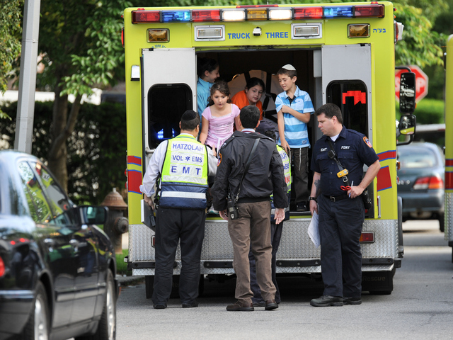 <p>Ben Azulai, 10, at right, with his 9-year-old sister Leeanne, is checked out by paramedics.</p>
