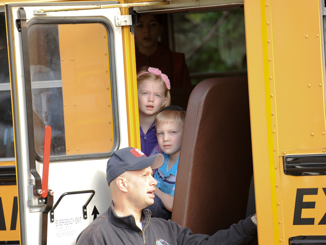 <p>Children on the bus wait to be checked out by paramedics on Tuesday June 5, 2012.</p>
