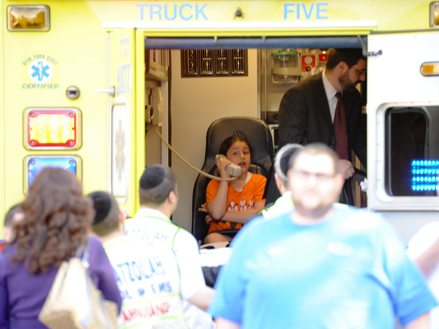 <p>A child uses a phone in an ambulance at the site of the crash on Tuesday June 5, 2012.</p>
