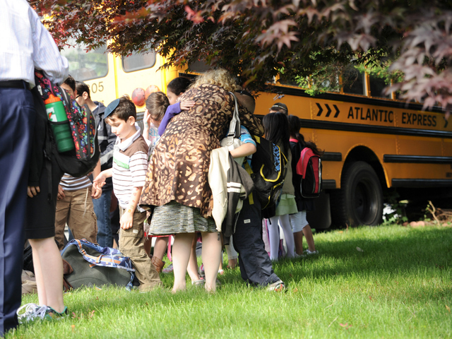 <p>A mother hugs her children at the scene of a school bus crash in Queens on Tuesday June 5, 2012.</p>
