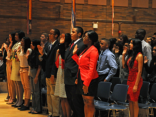 Students from city schools take an oath before spending the day with precinct commanders. 
