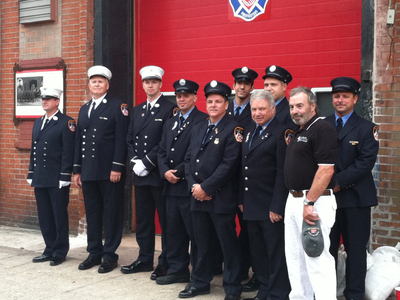 <p>Firemen with Engine 202, including Tony Catapano (second from right, in front), stand in front of the Friends of Firefighters building at 199 Van Brunt St. The company helped restore the property.</p>
