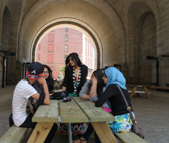 Young people enjoy hanging out at the new picnic tables. 