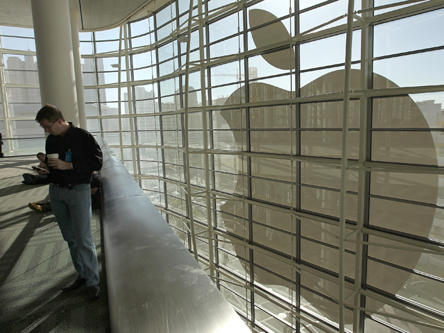 An attendee waits for Apple's Worldwide Developers Conference to start in San Francisco, June 11, 2012. 