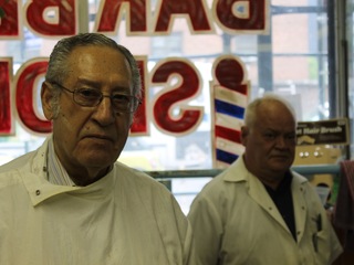 <p>A sign advertising affordable prices outside of Willies Barber Shop.</p>