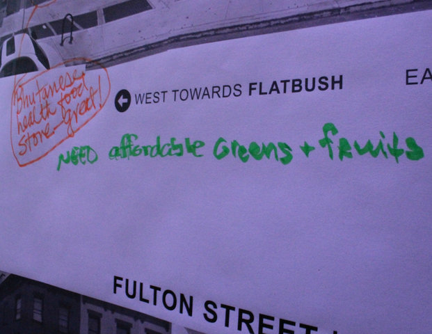 Participants write suggestions for Fulton Street on the wall. 