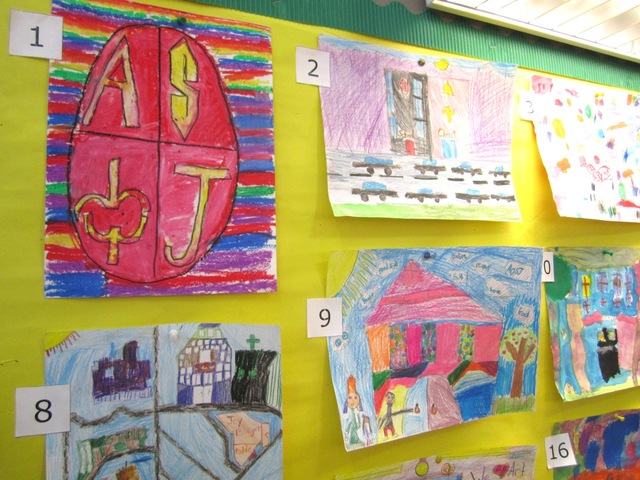 One bulletin board in the school's halls is decorated with logos for the school, made by its students.