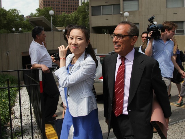 <p>John Liu's former campaign treasurer, Jenny Hou, smiles as she leaves court on July 10, 2012.</p>
