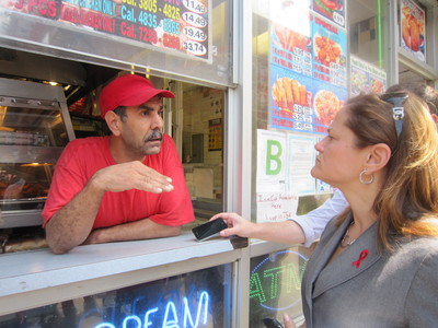 Lal Barak, owner of Crown Fried Chicken at Lexington Avenue and East 116th Street, tells East Harlem Councilwoman Melissa Mark-Viverito that Mayor Bloomberg's soda ban would hurt his business.