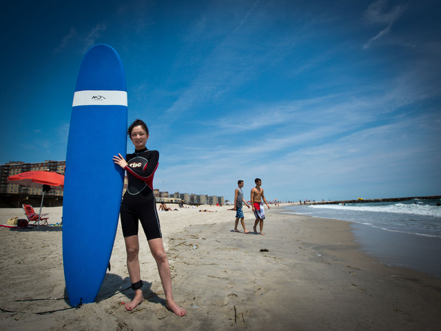 Akemi Tatsuta, 27, from Astoria with her surf board before heading to the beach.