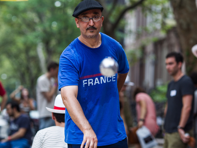 Kamel Gaiu, 51, from Marseille in France plays his favorite sport of petanque at Bastille Day in Brooklyn on July 15th, 2012.