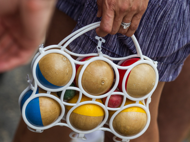 A player heads to a petanque game at Bastille Day in Brooklyn on July 15th, 2012.