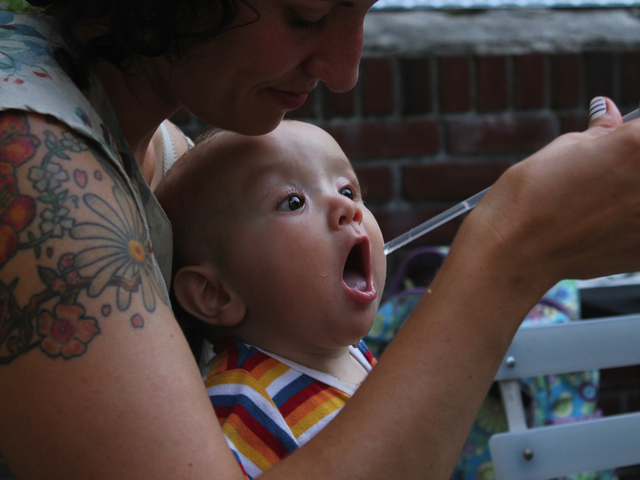 Heather Young cools off her nephew Lucas Carmona Young on the seating deck at Maggie Brown in Fort Greene.