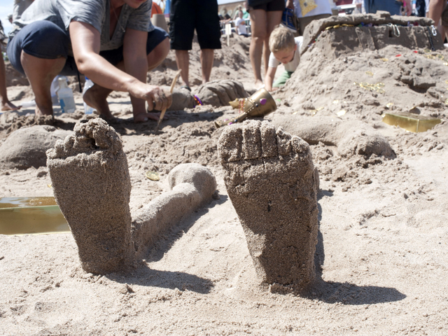 Feet protrude from a first prize winning sculpture on July 21, 2012 in the Coney Island Sand Sculpting contest.