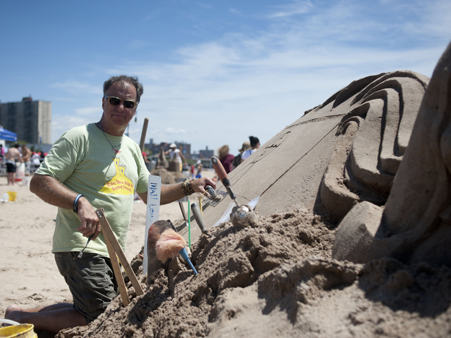 Professional Sand Sculptor Matt Long works on a piece commissioned by the Coney Island Redevelopment Corp. on July 21, 2012. Long will judge and run a lighthouse sand building contest at Midland Beach on August 25, 2012.