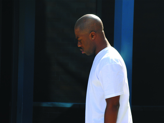 A man who family and friends identified as the son of one of the victims steps out from the hospital before heading back in on July 22, 2012. 
