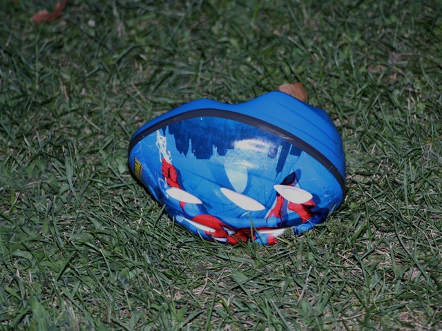 A child's bicycle helmet lay on the ground near the scene of the shooting Sunday, July 22, 2012.